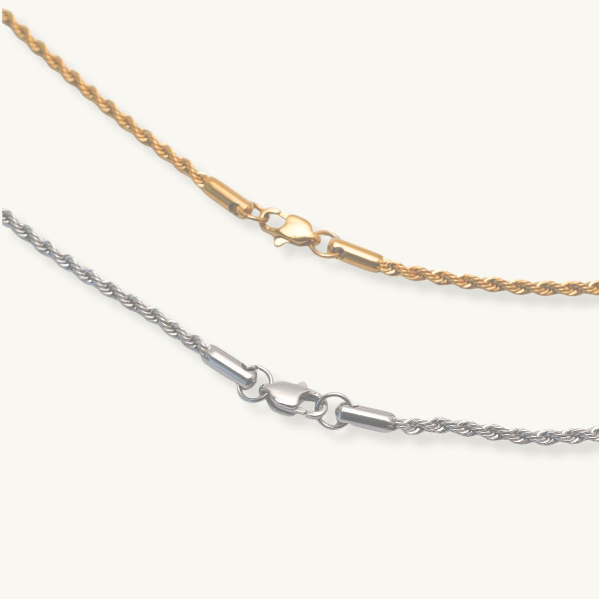Two gold and silver chain necklaces on a white background bar pendant