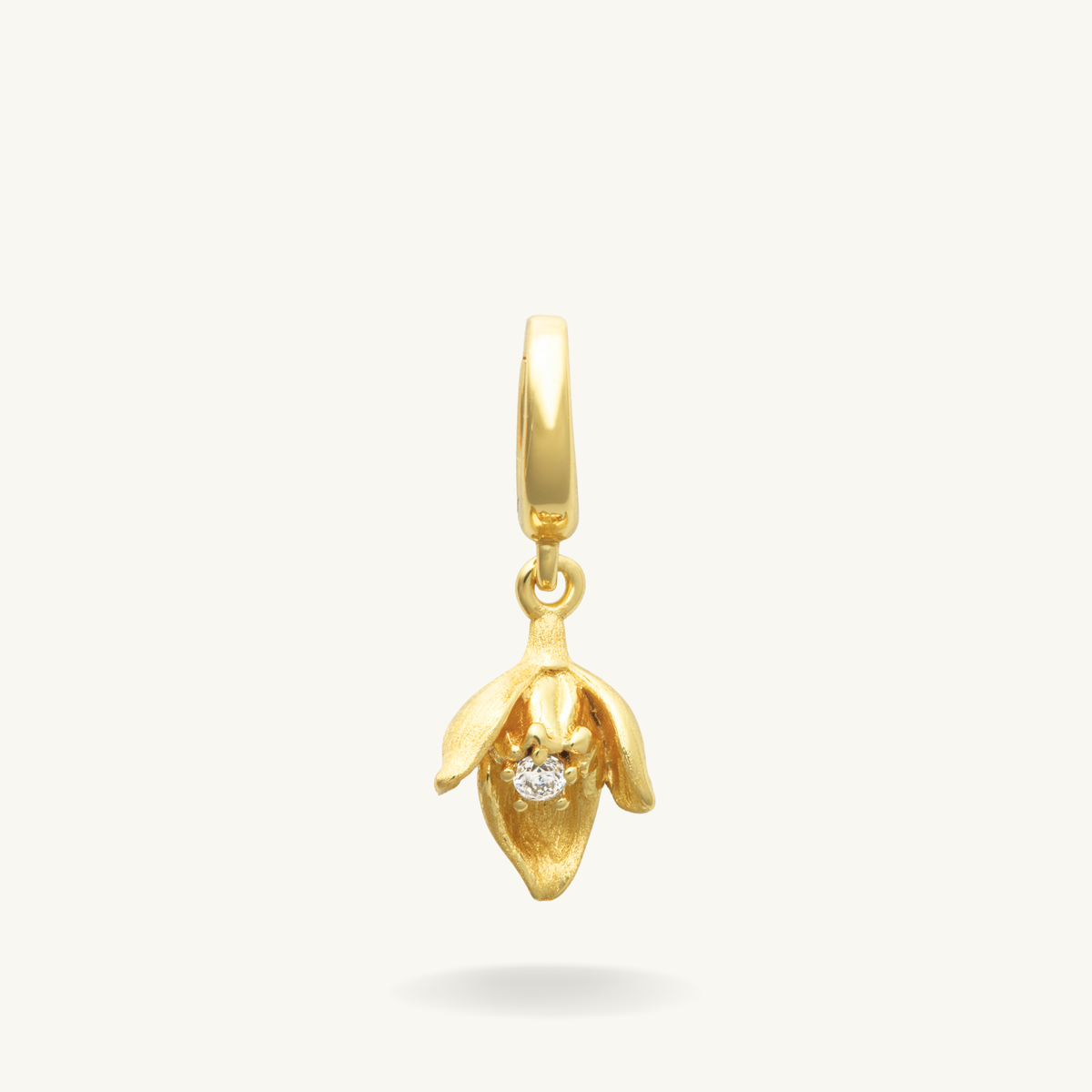 Snow drop gold vermeil pendant with a small stone on a white background